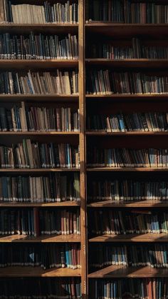 an old bookcase full of books with lots of bookshelves in the background