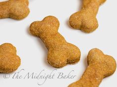 several small dog treats are on a white surface with the words, the midnight baker