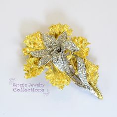 Fancy Yellow 18k gold Vintage Diamond Flower Brooch! This brooch separates into two different brooches. One is 18k white gold and set with 4.06 carats of diamonds. The larger 18k yellow gold brooch wraps around the inner brooch seamlessly. Please refer to one of the hand photos to view the pieces separated. Total Weight: 32.06 grams Size: 2.2 inches tall, 1.8 inch wide Precious Metal: 18k yellow gold Precious stones: -White Round Diamonds: 4.06 carats Hallmark: 18k Elegant Yellow Flower Brooches, Exquisite Diamond Brooches In Yellow Gold, Exquisite Yellow Gold Diamond Brooches, Diamond Flower Brooch For Formal Occasions, Formal Diamond Flower Brooch, Hand Photos, Diamond Flower Brooch, Hand Photo, Platinum Diamond Rings