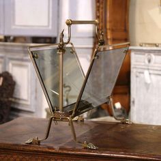 an antique looking mirror on top of a wooden table