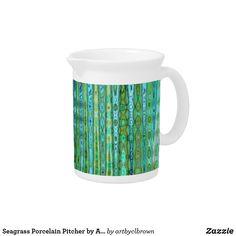 a pitcher with green and blue designs on it