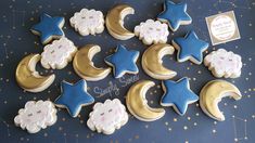 cookies decorated with stars, moon and clouds on a table