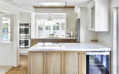 a kitchen with an island, stove and oven in it's center area is shown