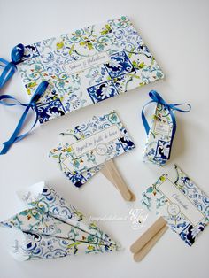 four pieces of blue and white paper on top of each other with tags attached to them