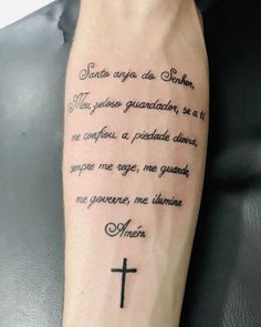 a person with a tattoo on their arm that has a cross and poem written in it