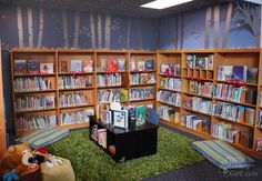 the children's library has many bookshelves and stuffed animals on the grass