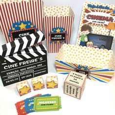 some movie themed items are sitting on a white table with red and yellow striped boxes