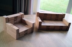 three cardboard boxes sitting on top of a wooden table