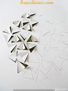 the paper is cut into triangles and placed on top of each other to make an origami effect