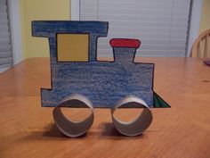 a paper craft train sitting on top of a wooden table