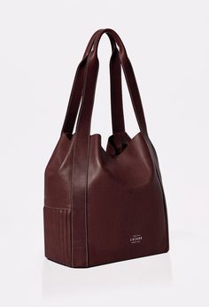 A timeless classic reimagined in a modern design. Thoughtfully crafted to be your perfect companion for day-to-day life. Its generous size makes it ideal for carrying your essentials while adding a touch of style to your everyday adventures. Classic Rectangular Hobo Bag For On-the-go, Classic Brown Bucket Bag For On-the-go, Modern Bucket Bags For On-the-go, Classic Everyday Canvas Shoulder Bag, Classic Everyday Satchel Shoulder Bag, Classic Everyday Bucket Shoulder Bag, Classic Bucket Hobo Bag For Everyday, Classic Satchel Shoulder Bag For Everyday, Timeless Everyday Satchel Shoulder Bag