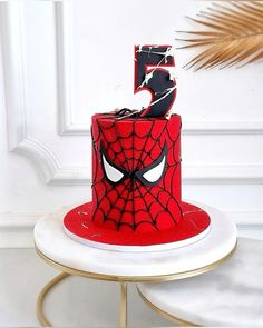 a spiderman birthday cake with the number five on it