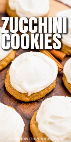 cookies with white frosting and cinnamon sticks on a cutting board next to the words zucchini cookies