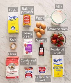 ingredients to make strawberry shortcakes laid out on a white marble counter top with text overlay