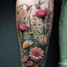 a woman's thigh with flowers and hummings on the side of her leg