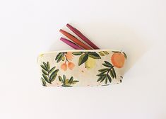 Here is a super sweet Rifle Paper Co zipper pouch.  Perfect for caring pencils and pens or all your little purse items. Outside fabric: Citrus Floral Canvas Lining: light pink cotton -Measures 8.5''L x 3'' H x 2'' -Zipper 8.5'' long ( color: white) -Pattern placement may vary -From a smoke free home studio -Listing for one zipper pouch, pens not included >>Handmade with love in California<< Pencil Pouch With Pen Slots, Green Zipper Pouch Stationery Gift, Pencil Shaped Zipper Pouch As Gift, Stationery Pouch With Pen Slots For Personal Use, Multicolor Stationery With Pen Slots As Gift, Paper Pencil, Floral Canvas, Gift Graduation, Pencil Pouch