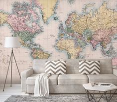 a living room with a large wall map on the wall and a couch in front of it