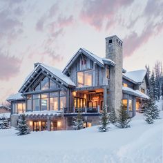 a large house is covered in snow at dusk