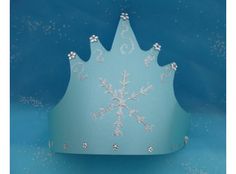 a tiara with snowflakes on it sitting in front of a blue background