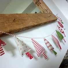 some red and white flags are hanging from a wooden beam on the wall next to a mirror