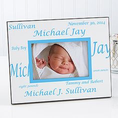 a baby's photo frame with a blue border and name on the front is shown