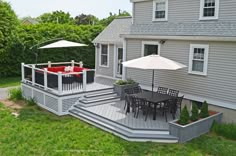 a deck with chairs and an umbrella on it