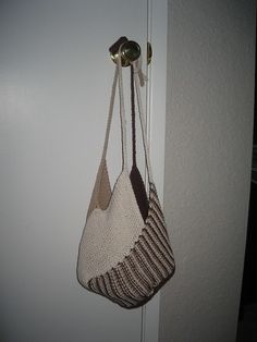 a purse hanging from the side of a door