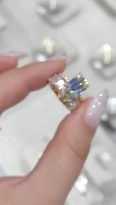 a person holding an engagement ring in their hand