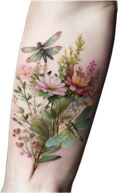 a woman's arm with flowers and dragonflies on it