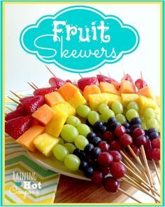 fruit skewers on a plate with strawberries and grapes