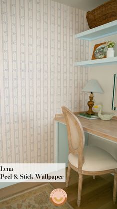 there is a desk and chair in the room with striped wallpaper on the walls