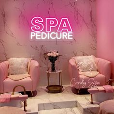 two pink chairs sitting next to each other in front of a sign that says spa pedicure