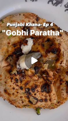 a plate with some food on it and the words gobi paratha written in white