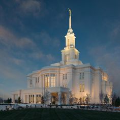 a large white building with a steeple at night