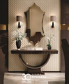 an elegant console table with vases and flowers on it in front of a mirror