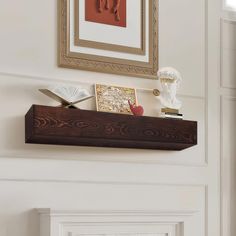 a wooden shelf with pictures and other items on it