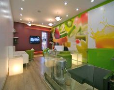 the interior of a modern living room with green and white furniture