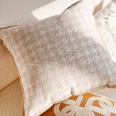 a close up of two pillows on a bed