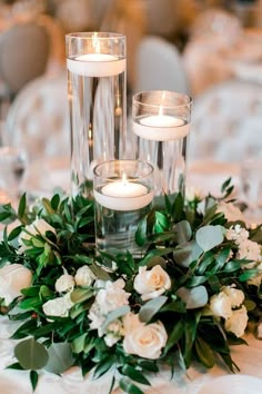 the centerpieces are filled with candles and flowers