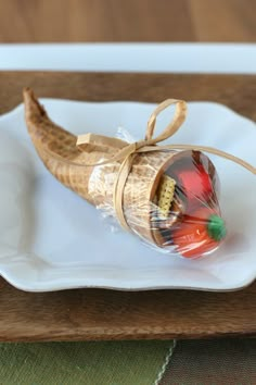 a candy filled banana on a white plate