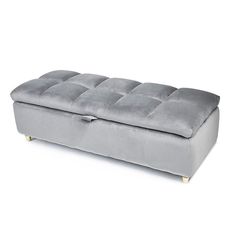 a grey velvet bench with wooden legs and footrests on an isolated white background