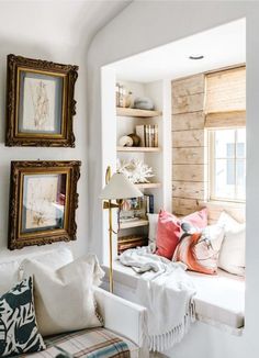 a living room filled with furniture and pictures on the wall next to a window sill