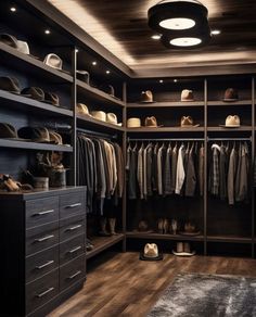 a walk - in closet with lots of clothes and hats on the shelves next to it