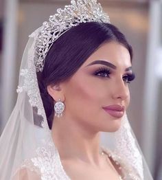 a woman wearing a wedding veil and tiara