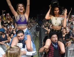 two women in bikinis standing on top of each other at a music festival with people behind them