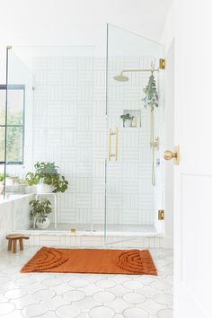 a bathroom with a rug, shower and bathtub in the middle of the room