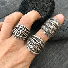 Three unique and powerful statement rings. The 3 of them are made in a braided, overlapping style that creates this unique chunky silver rings. Perfect everyday rings, that will rock your outfits, and are easy to match any other accessories. In one of the pictures, you can see which number represents each ring. Ring 1 is a size 8.5 Ring 2 is a size 8 Ring 3 is a size 8 All unique addition to your ring collection. To see more unique silver rings, click the link below https://www.etsy.com/shop/Aka Handmade Open Ring With Modern Twist, Handmade Open Ring With A Modern Twist, Unique Handmade Wide Band Round Ring, Handmade Unique Rings With Thick Band, Unique Handmade Rings With Thick Band, Handmade Adjustable Brutalist Jewelry, Handmade Wide Band Metal Ring, Unique Handmade Wide Band Rings, Unique Handmade Wide-band Rings