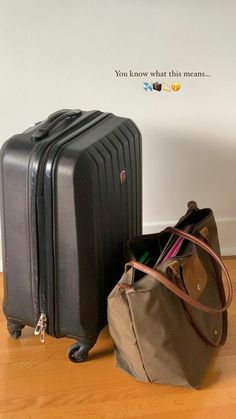 two pieces of luggage sitting on top of a hard wood floor next to a wall