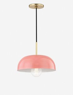 a pink and gold pendant light hanging from a ceiling