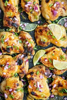 chicken with limes, onions and cilantro on a baking sheet